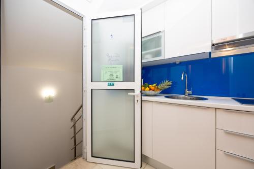 a kitchen with a refrigerator and a sink at Apartment Dome in Split