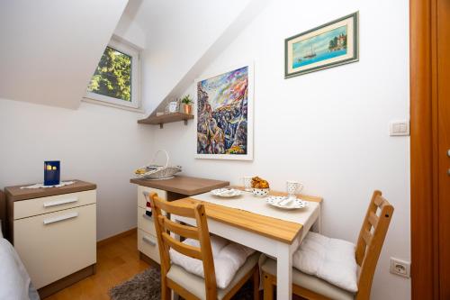 a small dining room with a table and chairs at Apartment Dome in Split