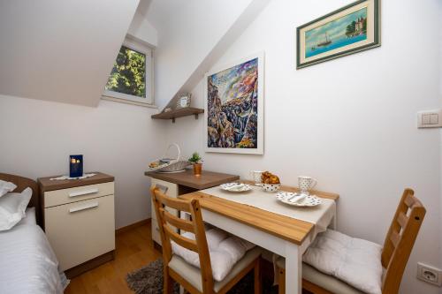 a room with a table and chairs and a bed at Apartment Dome in Split
