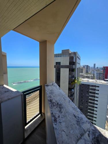 a balcony with a view of the ocean at Recife Mar Flats Hotel in Recife