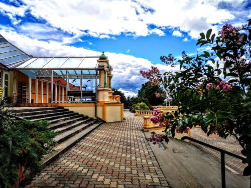a building with stairs and a clock tower on it at Kamala Kutir in Somogyvámos