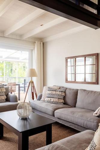 a living room with a couch and a table at Stay North - Mustikka in Lohja