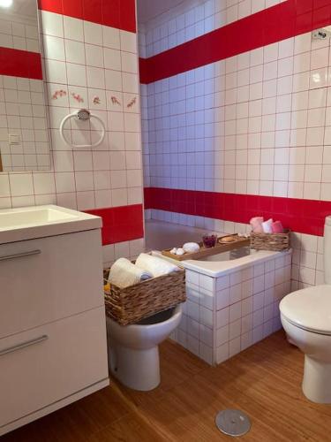 a bathroom with a toilet and a sink at La dama del mar in Punta Prima