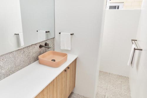 a bathroom with a sink and a mirror at The Elanora in Dunsborough