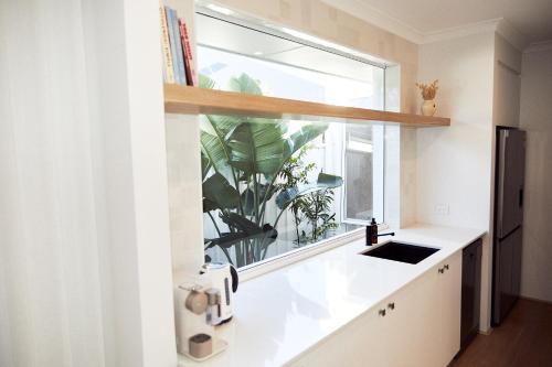 a kitchen with a window and a sink at The Elanora in Dunsborough