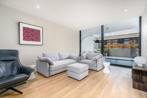 a living room with two couches and a table at Elegant Apartment in Kingston Foreshore - Hosted by Canstay in Kingston