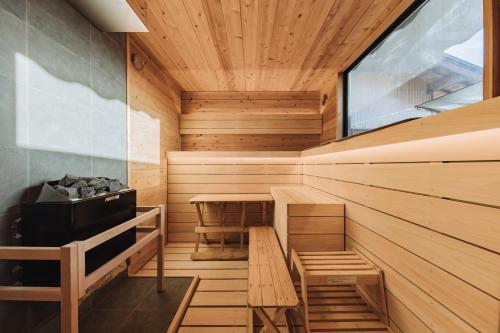 a sauna with a bench and a table in it at Riverside Sauna Base Conpeki in Taniai