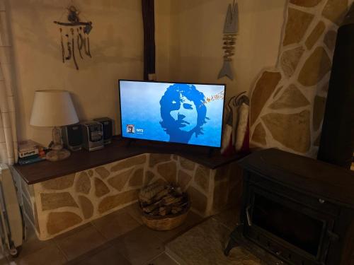 a television sitting on a shelf in a living room at Hoolit House in Vournikás