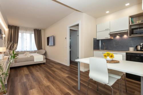 a kitchen and living room with a table and chairs at palazzo mazzini in Cornaredo