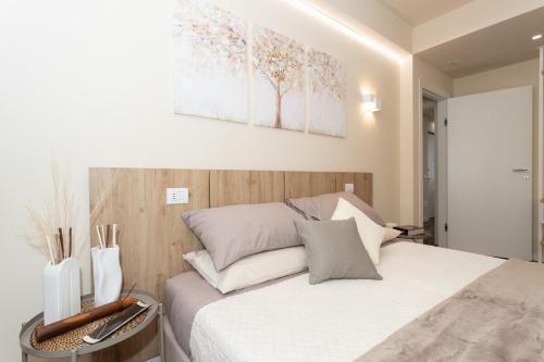 a bedroom with a bed with white sheets and pillows at palazzo mazzini in Cornaredo