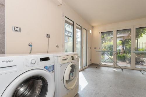 a laundry room with a washer and dryer in it at palazzo mazzini in Cornaredo