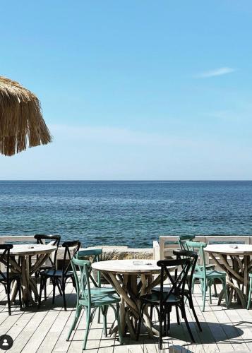 a group of tables and chairs on the beach at Hotel Plein Large in Bandol