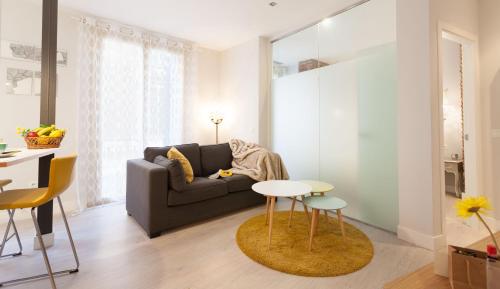 a living room with a couch and a table at Graffiti Suites Málaga in Málaga