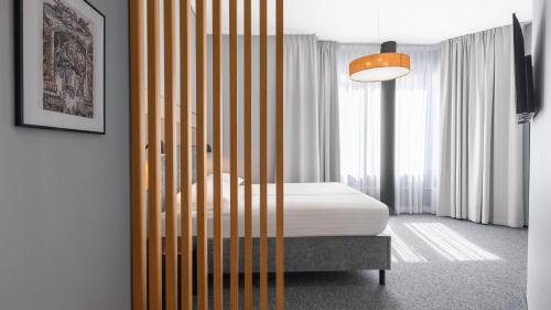 a bedroom with a bed with a wooden fence at Fonnental Design Hotel Tallinn in Tallinn