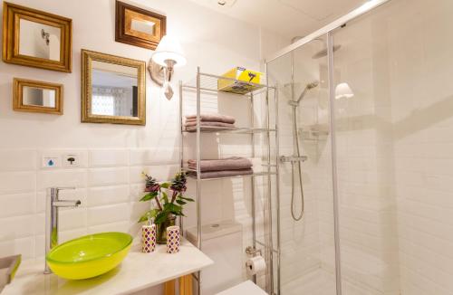 a bathroom with a glass shower and a sink at Graffiti Suites Málaga in Málaga