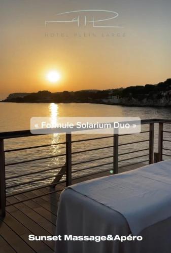 a view of the sunset from the deck of a boat at Hotel Plein Large in Bandol