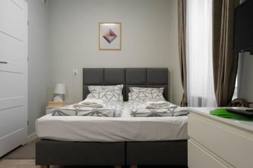 Postel nebo postele na pokoji v ubytování Wąska 5 Apartamenty