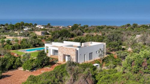 an aerial view of a house with a swimming pool at Quintessenza by Perle di Puglia in Torre Vado