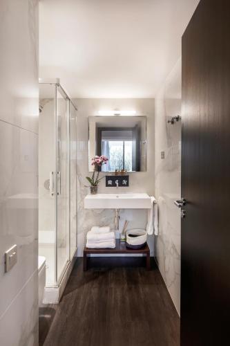 a bathroom with a sink and a toilet and a mirror at The Passage Homes - Simaba Group in Barcelona