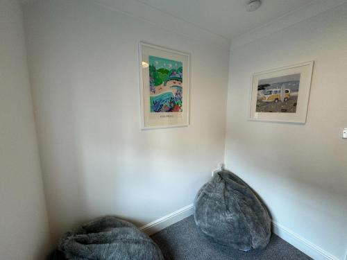 a room with two pictures on the wall at Wisteria House 3 bed sleeps 6 in Camelford