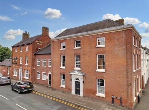 an old red brick building on a city street at The Wellington Suite, Garrick House in Lichfield