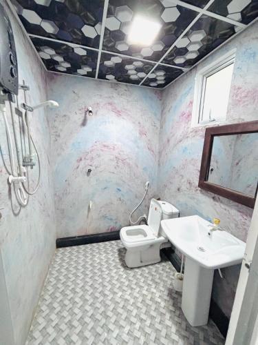 a bathroom with a toilet and a sink at Werala Beach Resort in Kalpitiya