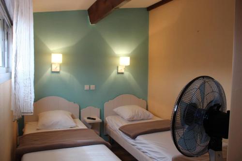Cette chambre comprend deux lits et un ventilateur. dans l'établissement Beau T3 avec piscine collective proche Port,plage et commerces-4JDN822, à Saint Cyprien Plage