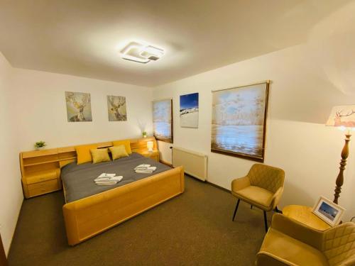 a bedroom with a bed and a chair in it at Gasthof Frasswirt in Frass