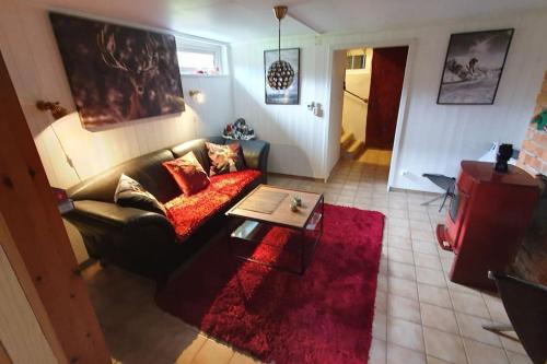 a living room with a couch and a table at Villa The White Moose, 6 rooms, 3 bedrooms, 2,5 baths, sauna, near Branäs in Likenäs