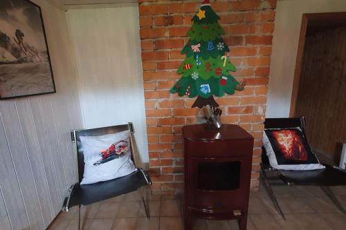 a living room with a christmas tree and a fireplace at Villa The White Moose, 6 rooms, 3 bedrooms, 2,5 baths, sauna, near Branäs in Likenäs