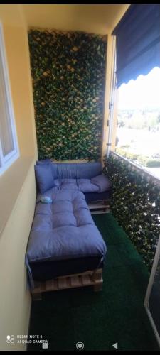 Cette chambre dispose d'un balcon avec un canapé. dans l'établissement Appartement 3 pièces Chenôve, à Chenôve