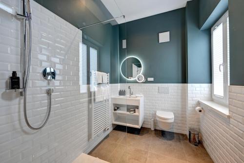 a bathroom with a shower and a sink and a toilet at Hotel Uhland in Munich