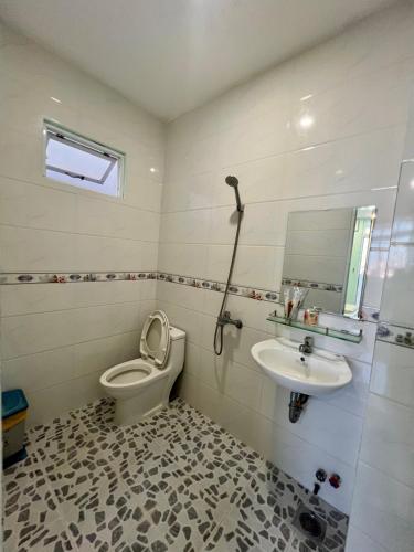 a bathroom with a toilet and a sink at HT Phuong Thao Boutique in Nha Trang
