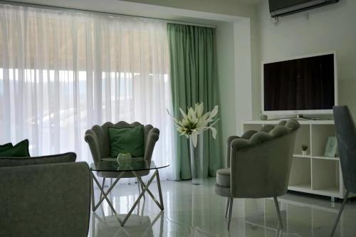 salon z dwoma krzesłami i telewizorem w obiekcie Merter Apartments w mieście Kawadarci