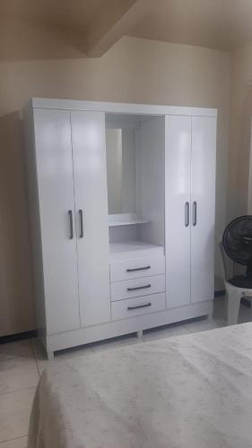 a large white cabinet in a living room at Casa Marataízes in Marataizes