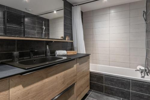 a bathroom with a sink and a bath tub at Cristal Des Alpes - Superb T3 - Vue Mont-Blanc in Les Houches