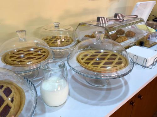 a counter topped with glass containers of milk and waffles at Hotel Martini in Naples