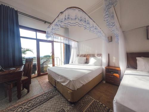 Postel nebo postele na pokoji v ubytování SeaBreeze Villas Nungwi