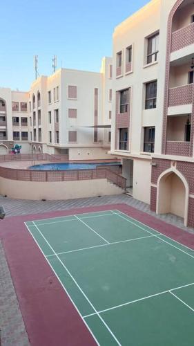 a tennis court in the middle of a building at Near City Centre Mall, Pool, Gym in Muscat