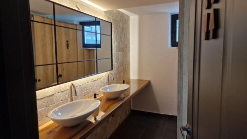 a bathroom with two sinks and a mirror at Rădăcini in Câmpulung Moldovenesc