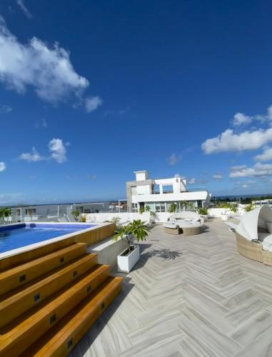 a view of a patio with a pool and a building at All Seasons Hotel in Bayahibe