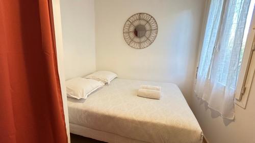 a small bedroom with a small bed with a mirror at Lafayette - Guyancourt in Guyancourt