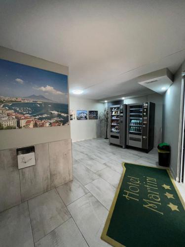 a large room with a green rug on the floor at Hotel Martini in Naples