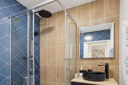 a bathroom with a sink and a shower at 862 Suite Tulipe - Superb apartment in Montreuil