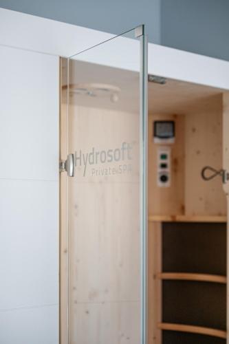 a glass door in a room with a closet at Hotel Trento Alta in Sardagna