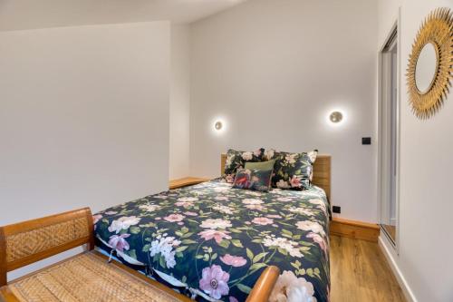 une chambre avec un lit avec un couvre-lit fleuri dans l'établissement Martin Bel F2 confortable, à Rouen