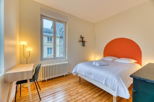 una camera da letto con un letto, una scrivania e una finestra di Emma Mignon F2 proche de la gare a Rouen