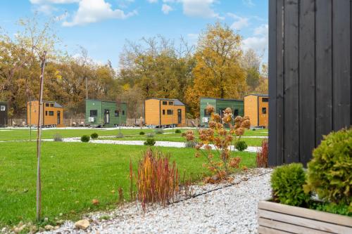 a row of houses in a park with a garden at Staymoovers - Tinyhouse Zator in Zator