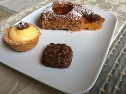 a plate with three different types of donuts on it at Palazzo Muro Leccese Relais de Charme & Wellness in Muro Leccese