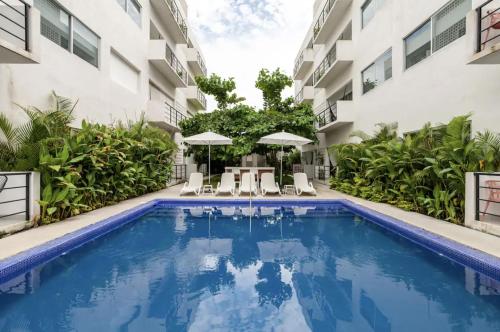a swimming pool in front of a building at Papaya Suites Diamante - Adults Only in Acapulco